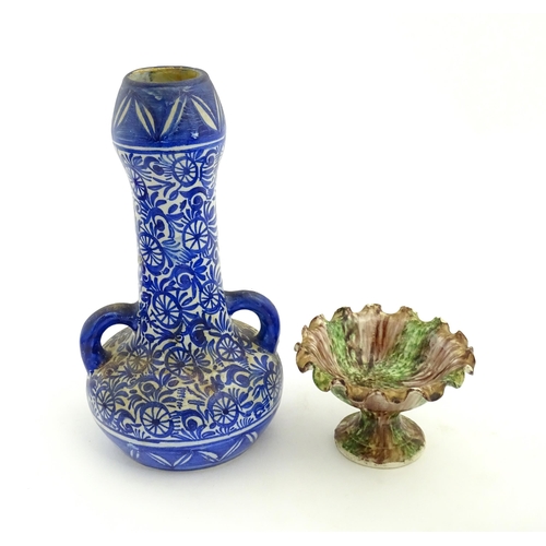 202 - A Moroccan blue and white vase with twin handles decorated with hand painted flowers. Together with ... 