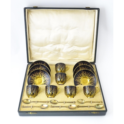 199 - A cased set of six Royal Worcester coffee cups and saucers with silver gilt spoons hallmarked London... 