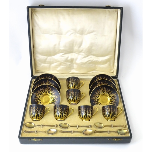 199 - A cased set of six Royal Worcester coffee cups and saucers with silver gilt spoons hallmarked London... 