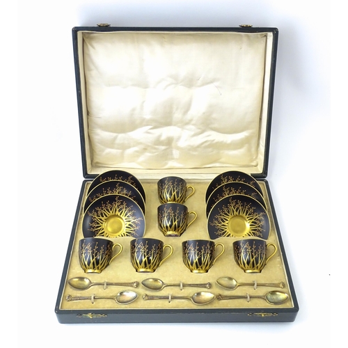 199 - A cased set of six Royal Worcester coffee cups and saucers with silver gilt spoons hallmarked London... 