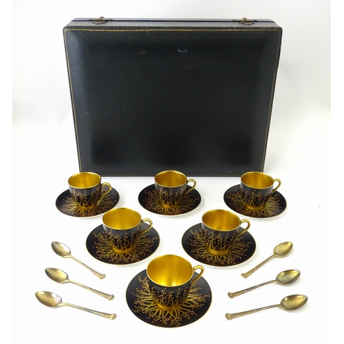 199 - A cased set of six Royal Worcester coffee cups and saucers with silver gilt spoons hallmarked London... 