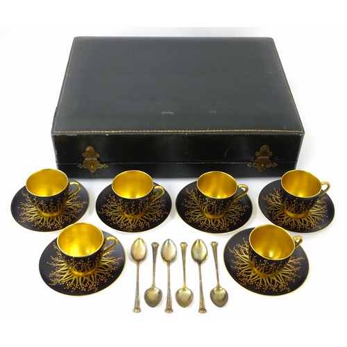 199 - A cased set of six Royal Worcester coffee cups and saucers with silver gilt spoons hallmarked London... 