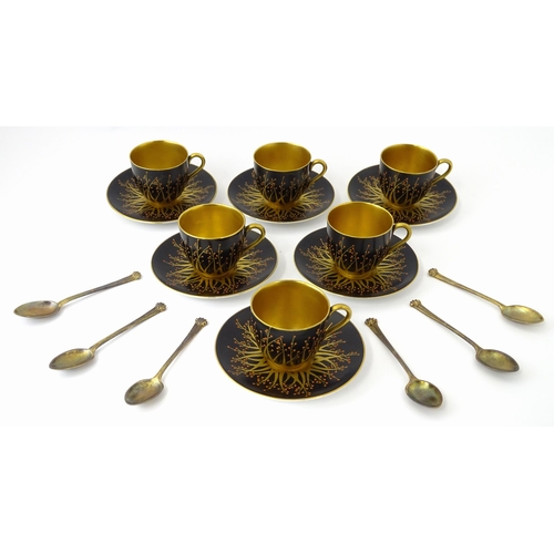 199 - A cased set of six Royal Worcester coffee cups and saucers with silver gilt spoons hallmarked London... 