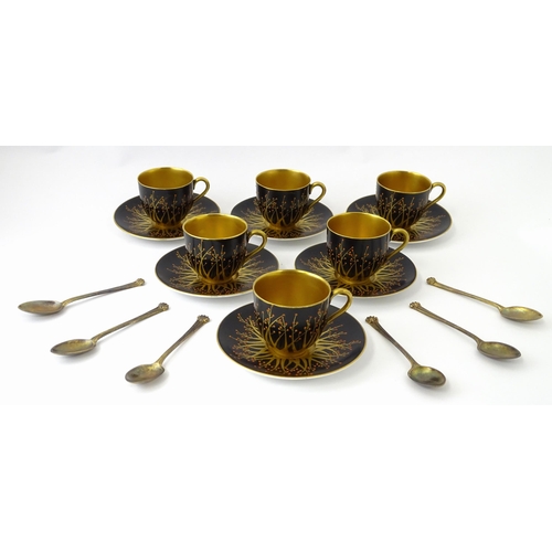 199 - A cased set of six Royal Worcester coffee cups and saucers with silver gilt spoons hallmarked London... 