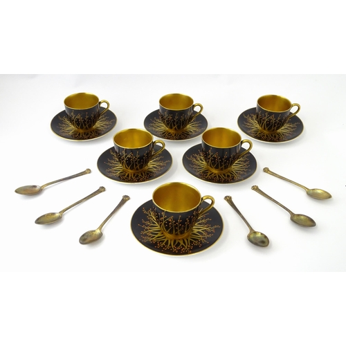 199 - A cased set of six Royal Worcester coffee cups and saucers with silver gilt spoons hallmarked London... 