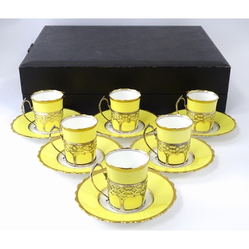 200 - A cased set of six Aynsley coffee cups and saucers, the cups with silver holders hallmarked Sheffiel... 