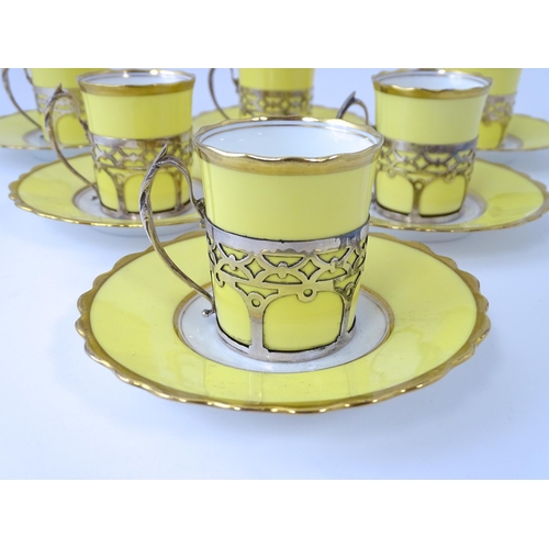 200 - A cased set of six Aynsley coffee cups and saucers, the cups with silver holders hallmarked Sheffiel... 