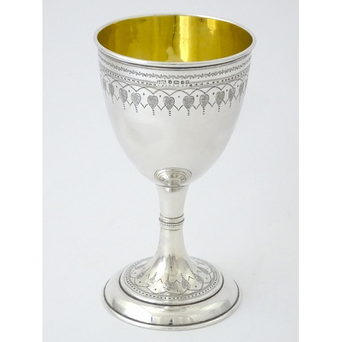 507 - A Victorian silver goblet with engraved decoration and gilded interior, hallmarked Sheffield 1876, m... 