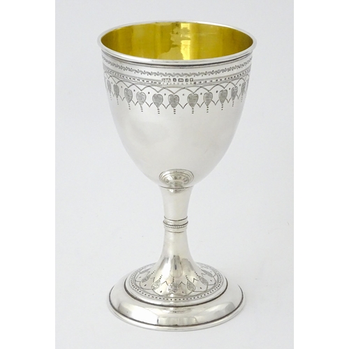 507 - A Victorian silver goblet with engraved decoration and gilded interior, hallmarked Sheffield 1876, m... 