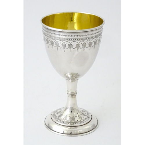 507 - A Victorian silver goblet with engraved decoration and gilded interior, hallmarked Sheffield 1876, m... 