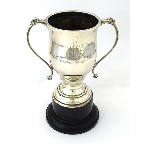 509 - A silver twin handled trophy cup bearing inscription for ' Schwarzkopf Golf Trophy Presented to P. D... 