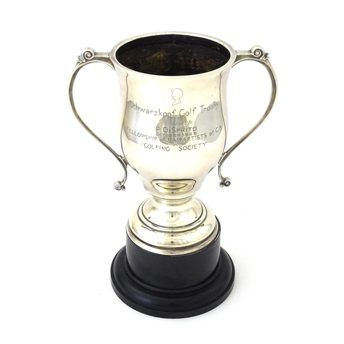 509 - A silver twin handled trophy cup bearing inscription for ' Schwarzkopf Golf Trophy Presented to P. D... 