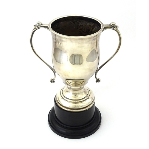 509 - A silver twin handled trophy cup bearing inscription for ' Schwarzkopf Golf Trophy Presented to P. D... 