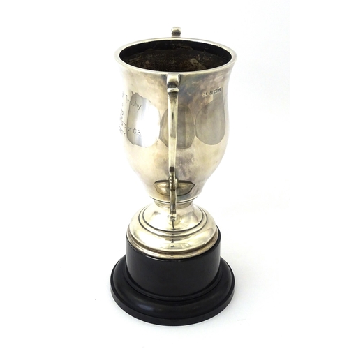 509 - A silver twin handled trophy cup bearing inscription for ' Schwarzkopf Golf Trophy Presented to P. D... 