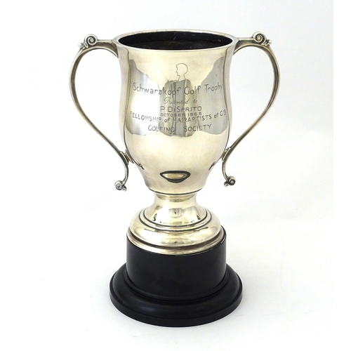 509 - A silver twin handled trophy cup bearing inscription for ' Schwarzkopf Golf Trophy Presented to P. D... 