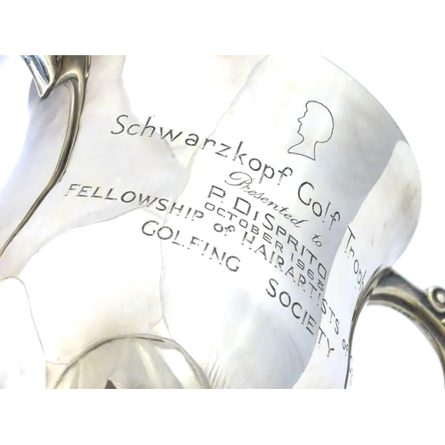 509 - A silver twin handled trophy cup bearing inscription for ' Schwarzkopf Golf Trophy Presented to P. D... 