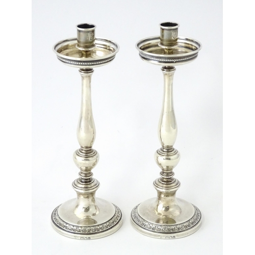 513 - A pair of silver taperstick holders hallmarked London 1910, maker Blunt & Ray. Approx. 6 3/4