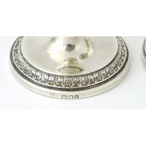 513 - A pair of silver taperstick holders hallmarked London 1910, maker Blunt & Ray. Approx. 6 3/4