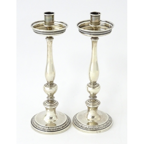 513 - A pair of silver taperstick holders hallmarked London 1910, maker Blunt & Ray. Approx. 6 3/4