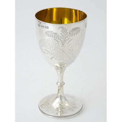 522 - A Victorian silver goblet with engraved foliate decoration and gilded interior, hallmarked London 18... 