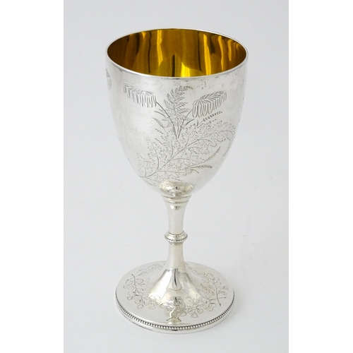 522 - A Victorian silver goblet with engraved foliate decoration and gilded interior, hallmarked London 18... 