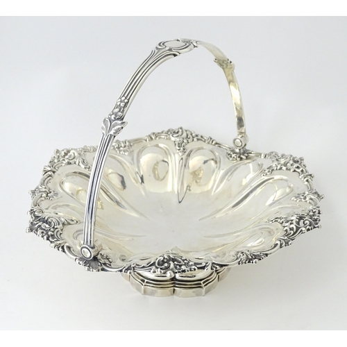 523 - A Victorian silver cake basket of pedestal form with swing handle, hallmarked Sheffield 1868, maker ... 