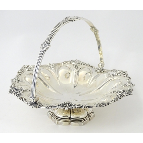 523 - A Victorian silver cake basket of pedestal form with swing handle, hallmarked Sheffield 1868, maker ... 