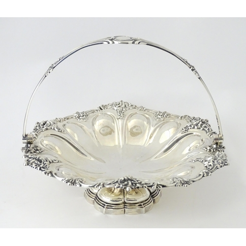 523 - A Victorian silver cake basket of pedestal form with swing handle, hallmarked Sheffield 1868, maker ... 