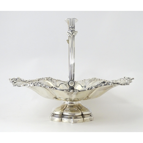 523 - A Victorian silver cake basket of pedestal form with swing handle, hallmarked Sheffield 1868, maker ... 