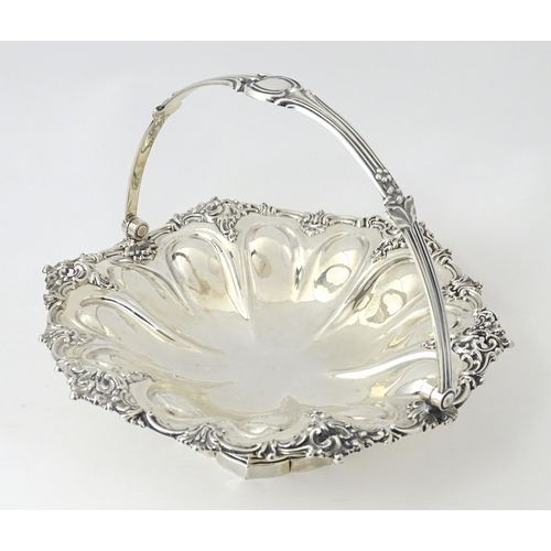 523 - A Victorian silver cake basket of pedestal form with swing handle, hallmarked Sheffield 1868, maker ... 