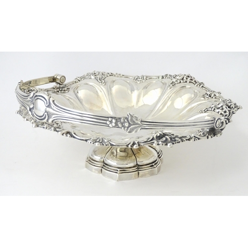 523 - A Victorian silver cake basket of pedestal form with swing handle, hallmarked Sheffield 1868, maker ... 