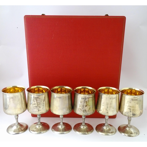 525 - A cased set of six Queen Elizabeth II silver goblets with gilded interiors and textured stems, hallm... 