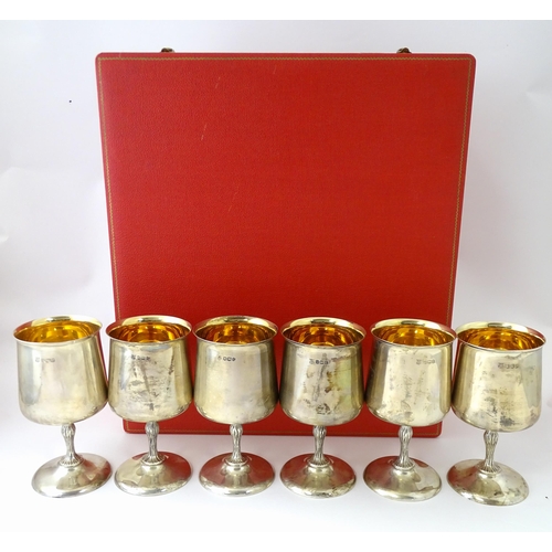 525 - A cased set of six Queen Elizabeth II silver goblets with gilded interiors and textured stems, hallm... 