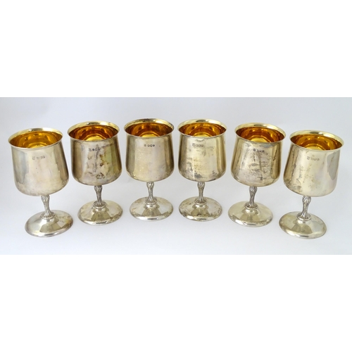 525 - A cased set of six Queen Elizabeth II silver goblets with gilded interiors and textured stems, hallm... 