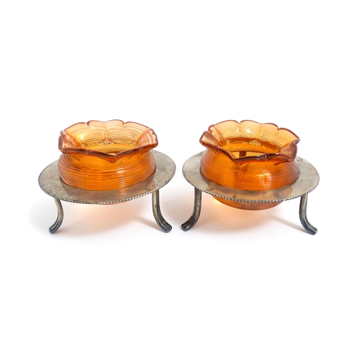 211 - A pair of glass posy holders with match striker bodies, with silver plate stands of circular form. A... 