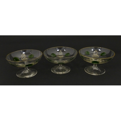 251 - WITHDRAWN FROM AUCTION - A set of six pedestal glasses with champagne coupe style bowls and green de... 