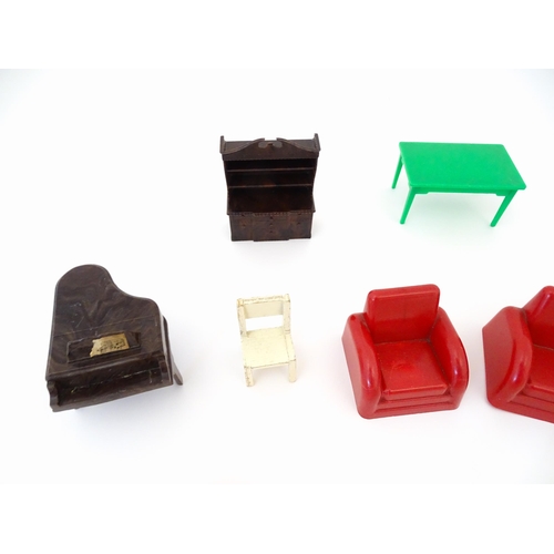 865 - Toys: A quantity of assorted dolls house furniture to include beds, chest of drawers, basin, bath an... 