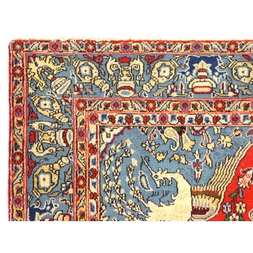 1361 - Carpet / rug : A Central Persian Isfahan rug, the red and blue grounds decorated with various birds,... 