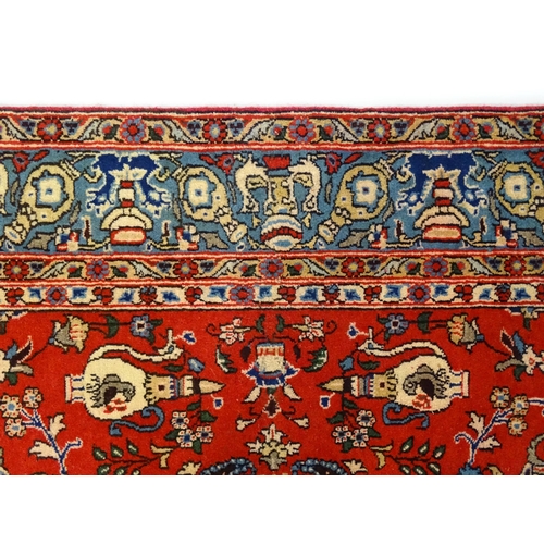 1361 - Carpet / rug : A Central Persian Isfahan rug, the red and blue grounds decorated with various birds,... 