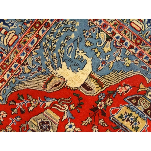 1361 - Carpet / rug : A Central Persian Isfahan rug, the red and blue grounds decorated with various birds,... 