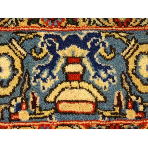 1361 - Carpet / rug : A Central Persian Isfahan rug, the red and blue grounds decorated with various birds,... 