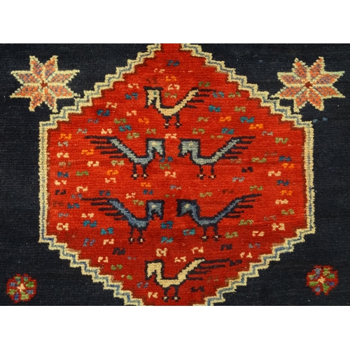 1365 - Carpet / Rug : A North East persian Kurdish Runner. The dark ground decorated with repeating medalli... 