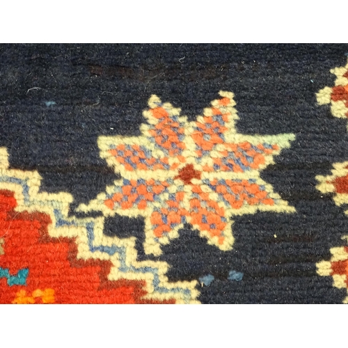 1365 - Carpet / Rug : A North East persian Kurdish Runner. The dark ground decorated with repeating medalli... 