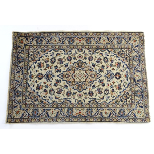 1366 - Carpet / Rug : A Central Persian Kashan rug having cream, and beige grounds decorated with floral an... 