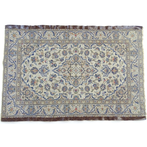 1366 - Carpet / Rug : A Central Persian Kashan rug having cream, and beige grounds decorated with floral an... 