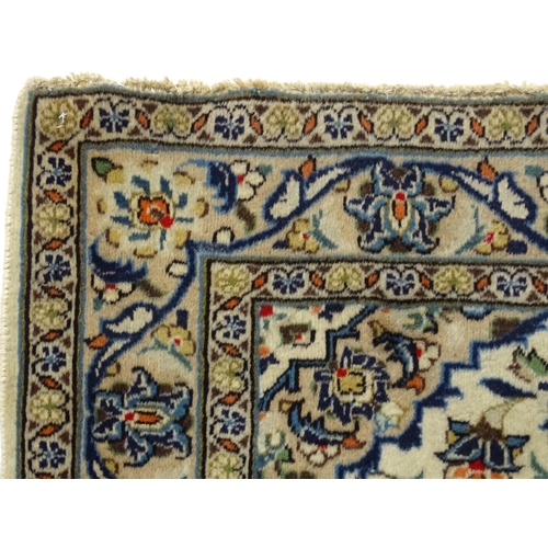 1366 - Carpet / Rug : A Central Persian Kashan rug having cream, and beige grounds decorated with floral an... 