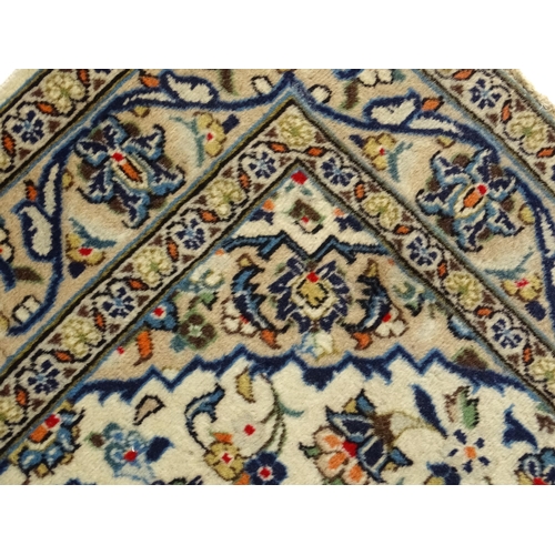 1366 - Carpet / Rug : A Central Persian Kashan rug having cream, and beige grounds decorated with floral an... 