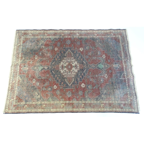 1372 - Carpet / Rug : A  North west Persian Koliahee rug with dark red and blue grounds and central cream g... 