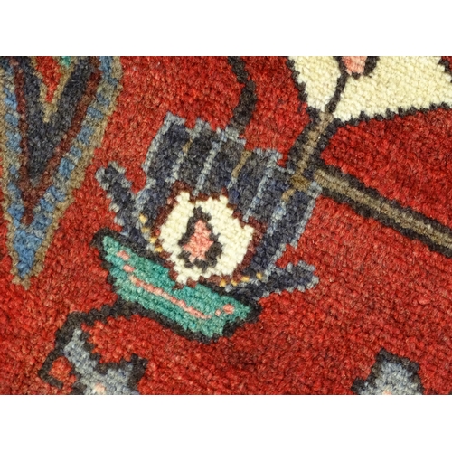 1372 - Carpet / Rug : A  North west Persian Koliahee rug with dark red and blue grounds and central cream g... 