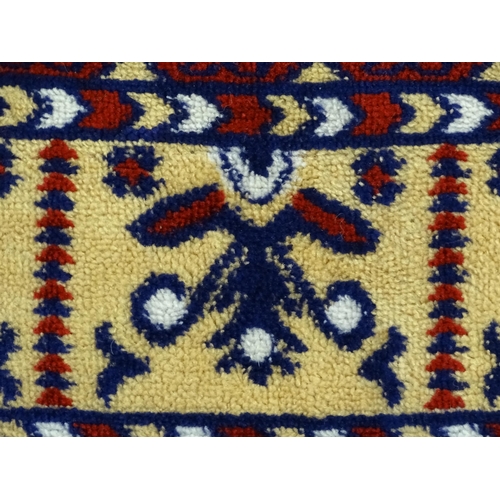 1385 - Carpet / Rug : A red ground rug decorated with repeating floral and geometric motifs. Approx. 79